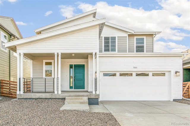 view of front of home with an attached garage, covered porch, and concrete driveway