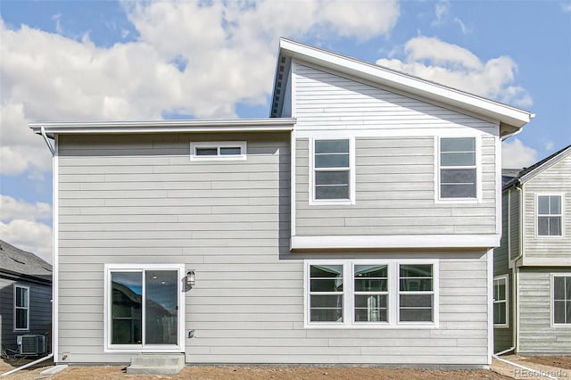 rear view of property with central AC unit