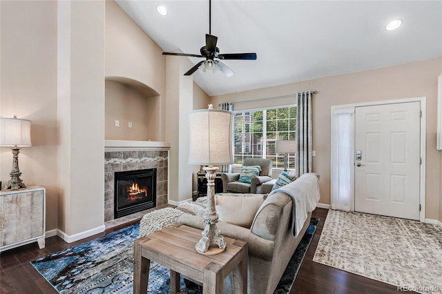 living room with recessed lighting, a fireplace, baseboards, and wood finished floors