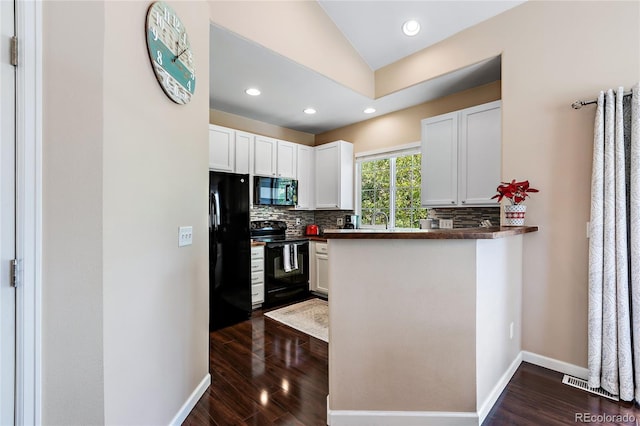 kitchen featuring decorative backsplash, dark countertops, white cabinets, and black appliances