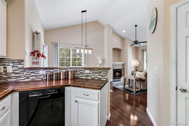 kitchen featuring tasteful backsplash, lofted ceiling, open floor plan, butcher block countertops, and dishwasher