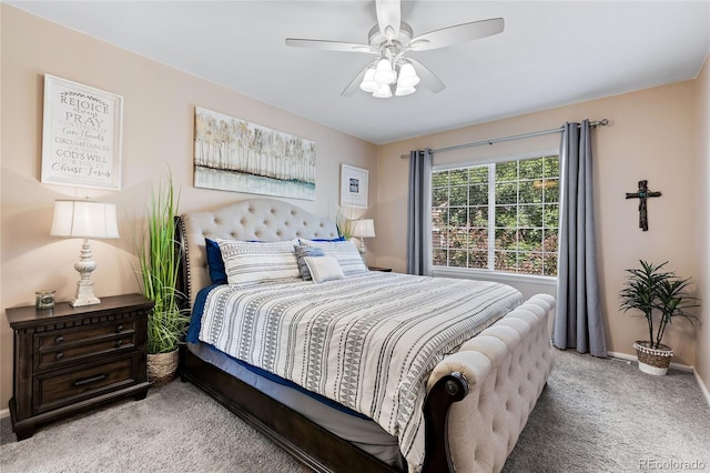 bedroom with baseboards, a ceiling fan, and light colored carpet