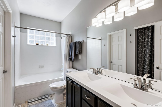 full bath with  shower combination, a sink, toilet, and double vanity