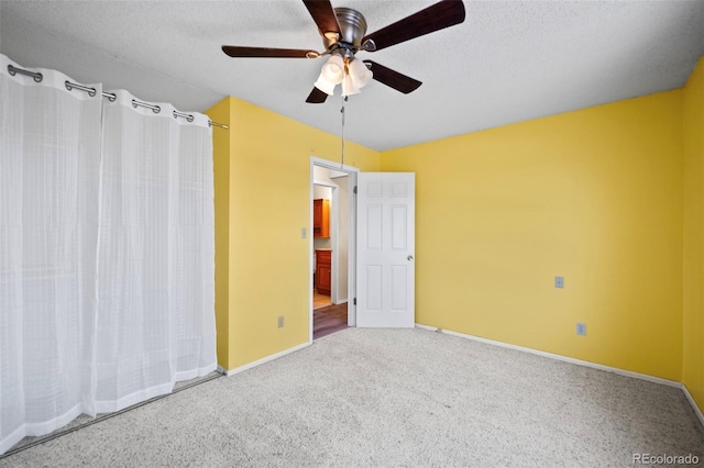 unfurnished bedroom featuring a textured ceiling, ceiling fan, and carpet