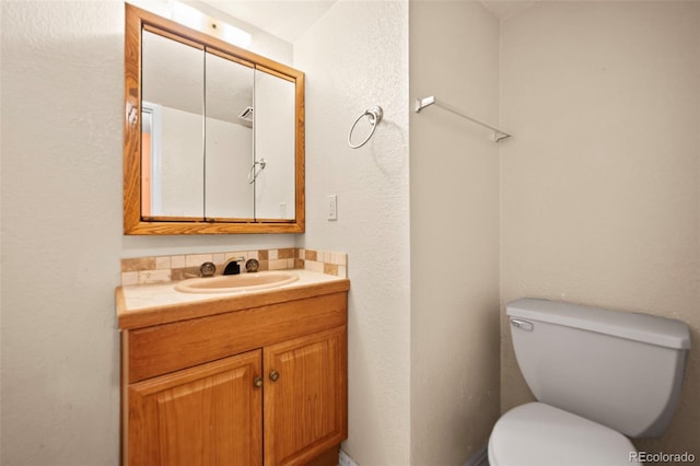 bathroom with toilet and vanity