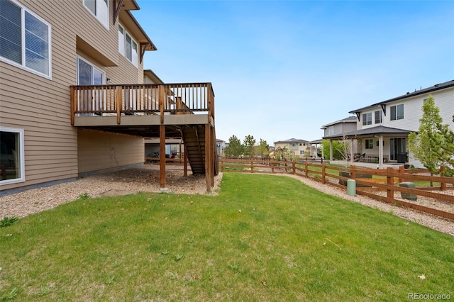 view of yard featuring stairway, fence, and a wooden deck