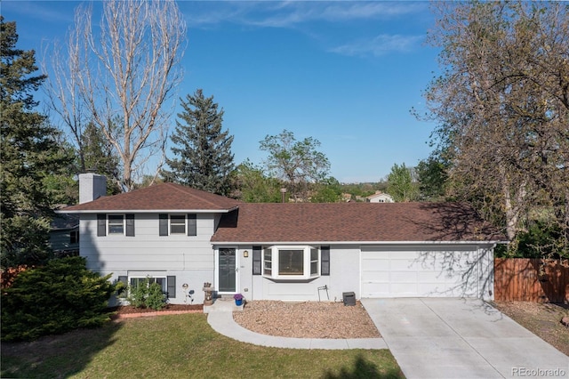 4374 E Peakview Cir, Centennial, CO 80121 - tri-level home featuring concrete driveway, a chimney, a garage, and roof with shingles