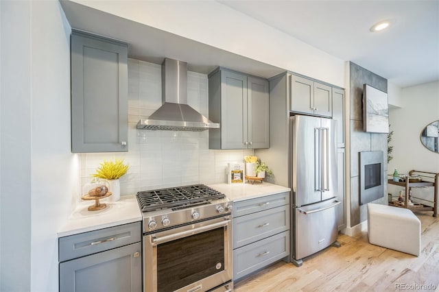 4922 Lowell Blvd Unit 3, Denver, CO 80221 - kitchen with stainless steel appliances, wall chimney exhaust hood, gray cabinets, and recessed lighting