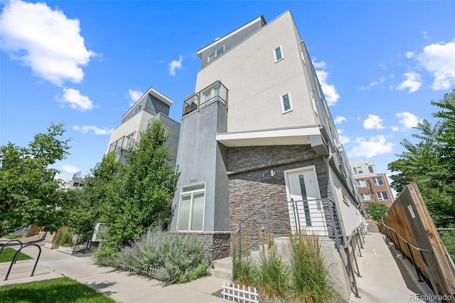 4922 Lowell Blvd Unit 3, Denver, CO 80221 - rear view of house featuring stone siding and stucco siding