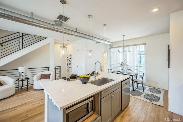 4922 Lowell Blvd Unit 3, Denver, CO 80221 - kitchen with appliances with stainless steel finishes, light wood-style floors, gray cabinetry, open floor plan, and recessed lighting