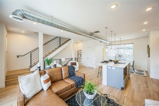 4922 Lowell Blvd Unit 3, Denver, CO 80221 - living room with stairway, light wood-style floors, and recessed lighting