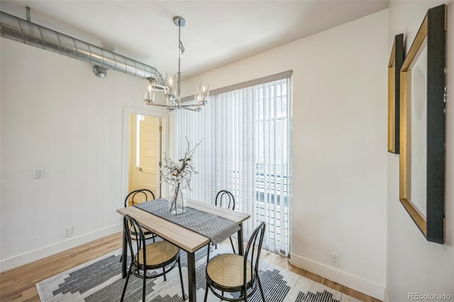 4922 Lowell Blvd Unit 3, Denver, CO 80221 - dining area featuring a chandelier and light wood-type flooring