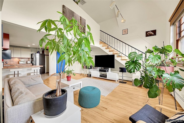 2351 Federal Blvd Unit 401, Denver, CO 80211 - living area with light wood-style flooring, stairway, and a high ceiling