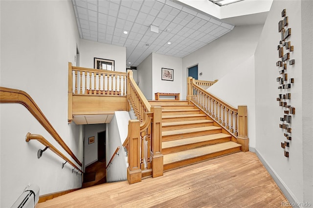 2351 Federal Blvd Unit 401, Denver, CO 80211 - stairway featuring baseboard heating, a paneled ceiling, and wood finished floors