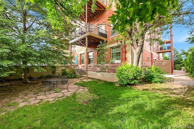 2351 Federal Blvd Unit 401, Denver, CO 80211 - rear view of property with brick siding, a balcony, and a patio area