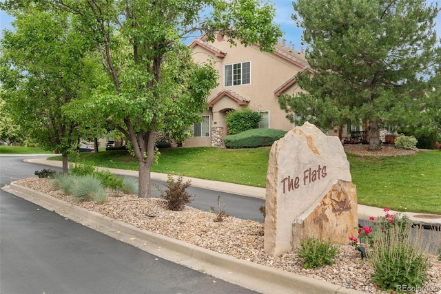 10760 Eliot Cir Unit 204, Denver, CO 80234 - view of front of house with a front yard, stucco siding, and a tiled roof