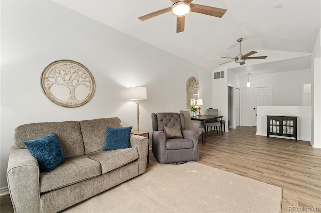 10760 Eliot Cir Unit 204, Denver, CO 80234 - living room featuring a ceiling fan, vaulted ceiling, and wood finished floors