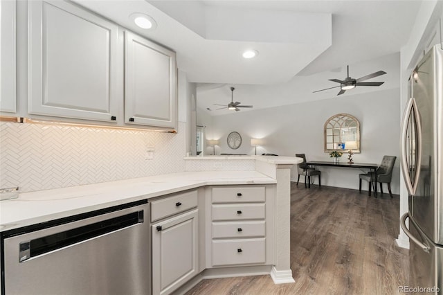 10760 Eliot Cir Unit 204, Denver, CO 80234 - kitchen featuring appliances with stainless steel finishes, a ceiling fan, decorative backsplash, lofted ceiling, and recessed lighting
