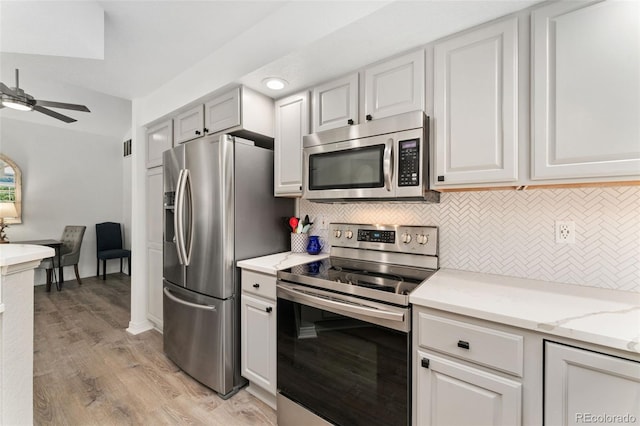 10760 Eliot Cir Unit 204, Denver, CO 80234 - kitchen with stainless steel appliances, decorative backsplash, a ceiling fan, light wood-type flooring, and light stone countertops