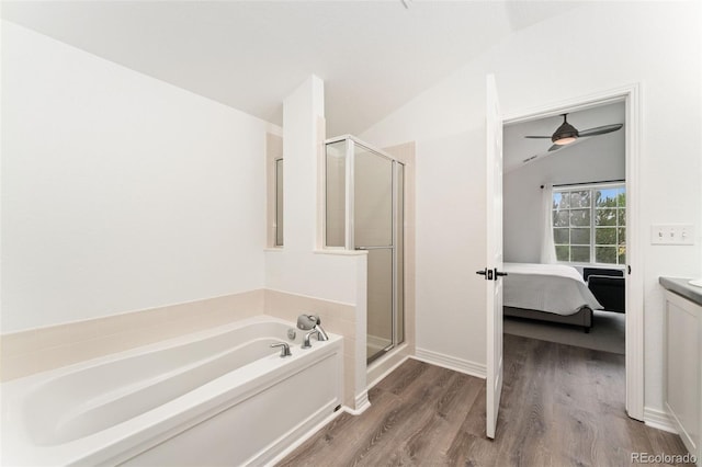 10760 Eliot Cir Unit 204, Denver, CO 80234 - bathroom featuring a garden tub, connected bathroom, a shower stall, wood finished floors, and lofted ceiling