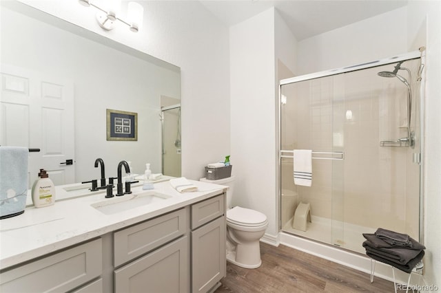 10760 Eliot Cir Unit 204, Denver, CO 80234 - full bath featuring wood finished floors, vanity, and a stall shower