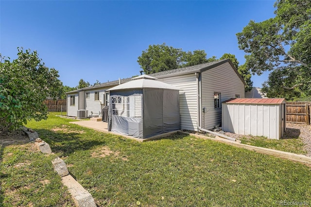 4849 S Pitkin Way, Aurora, CO 80015 - rear view of house with a storage unit, a gazebo, and a patio area