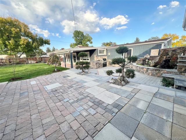 rear view of house featuring a yard and a patio