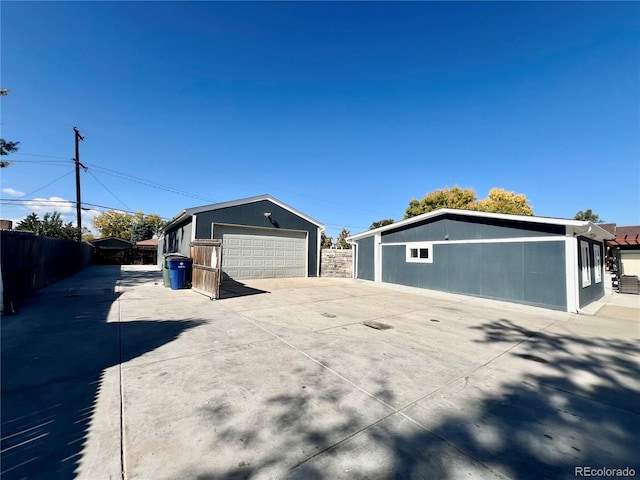 view of property exterior featuring an outdoor structure and a garage