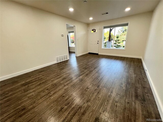 spare room with dark hardwood / wood-style floors