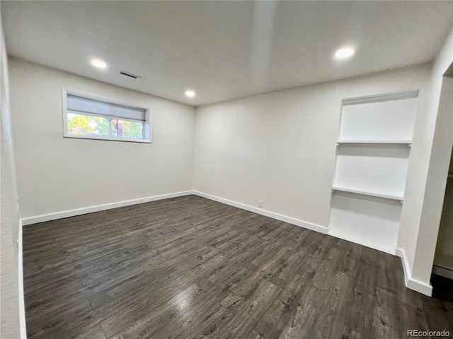 spare room featuring dark wood-type flooring