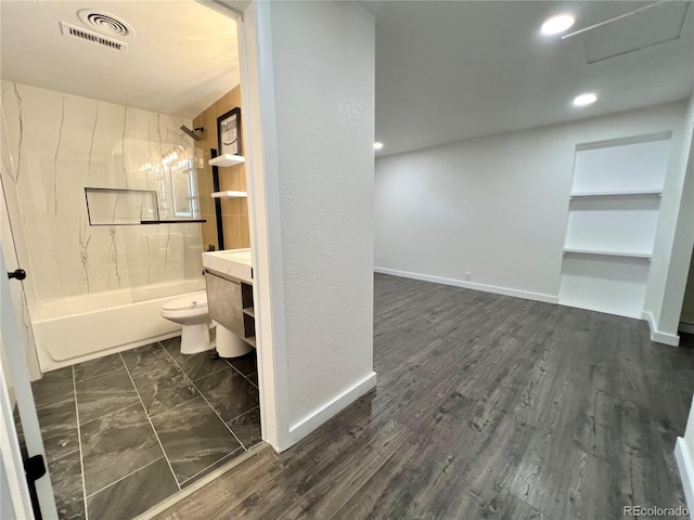 full bathroom with tub / shower combination, vanity, toilet, and wood-type flooring