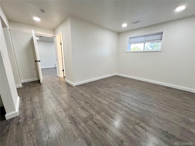 unfurnished room with dark hardwood / wood-style floors