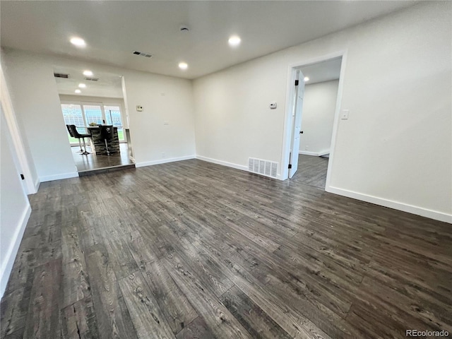 empty room with dark wood-type flooring