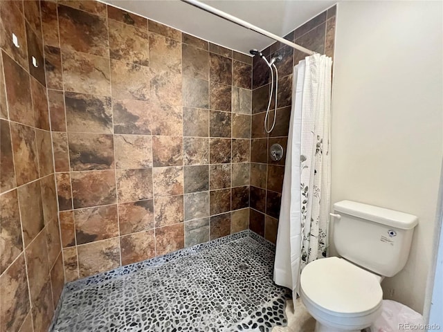 bathroom featuring tile patterned floors, toilet, and walk in shower