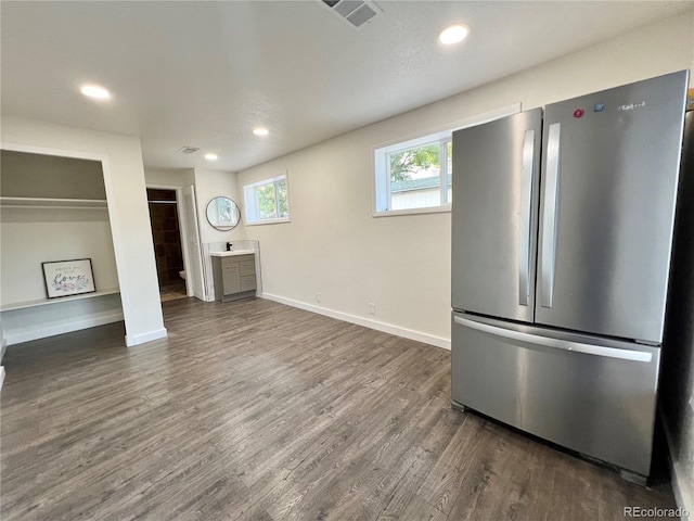 kitchen featuring dark wood-type flooring and stainless steel refrigerator