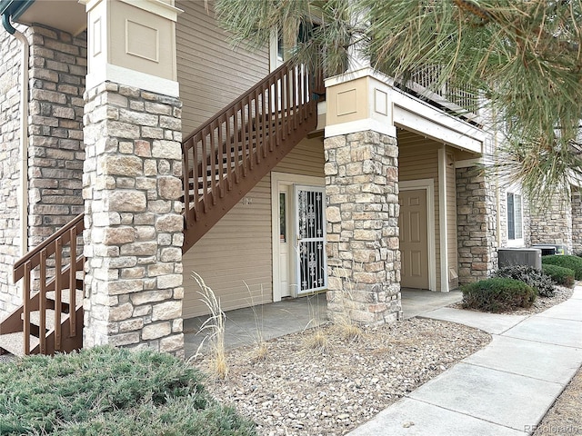 entrance to property featuring stone siding