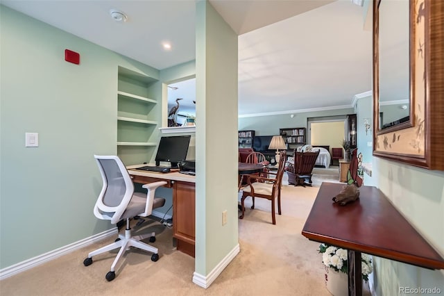 office featuring baseboards, light colored carpet, and built in shelves