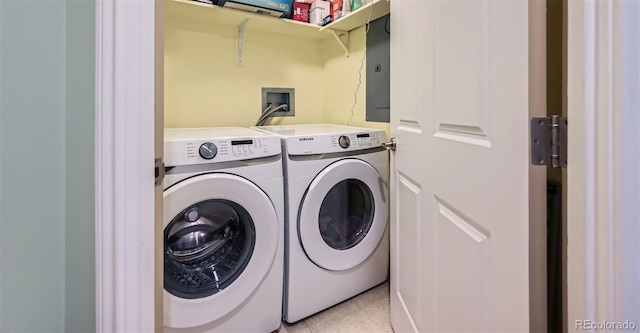 laundry room featuring electric panel, independent washer and dryer, light tile patterned flooring, and laundry area