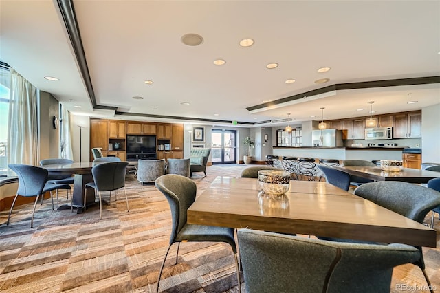 dining room featuring recessed lighting and a raised ceiling