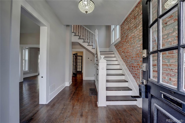 entryway featuring a chandelier and dark wood-type flooring