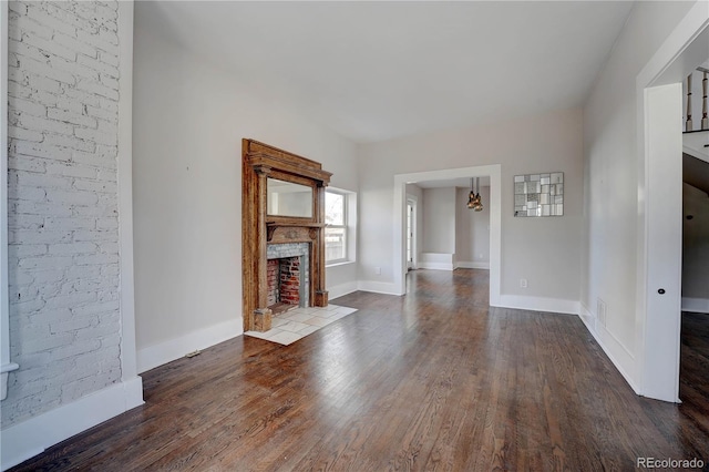 unfurnished living room featuring dark wood-type flooring