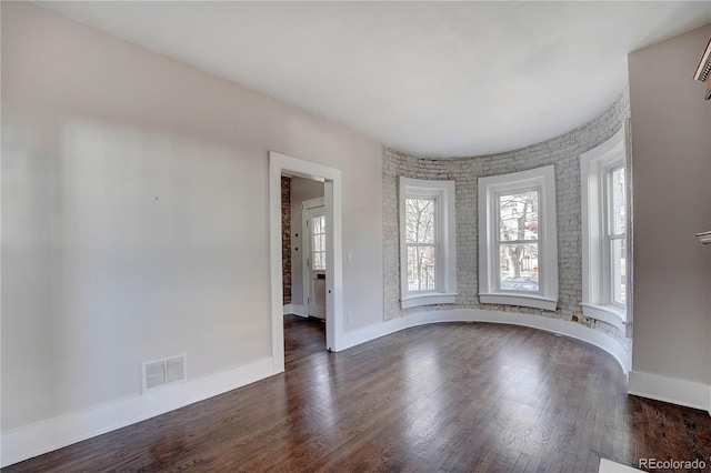 empty room with dark hardwood / wood-style flooring