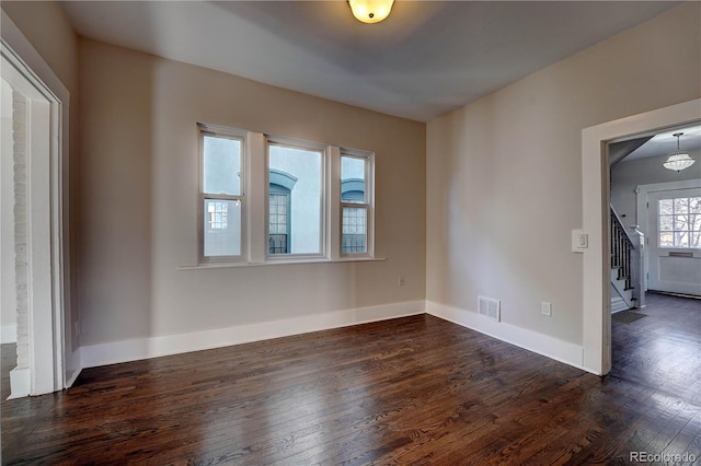 empty room featuring dark hardwood / wood-style flooring