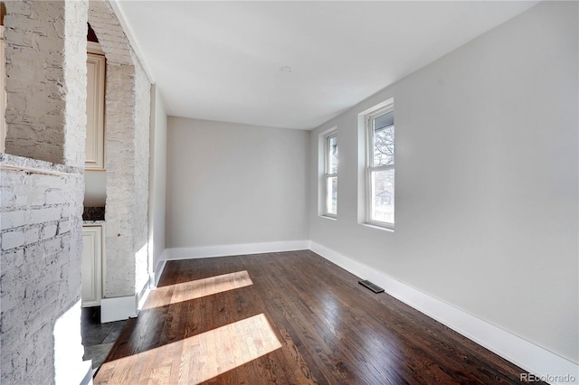 unfurnished room featuring dark wood-type flooring