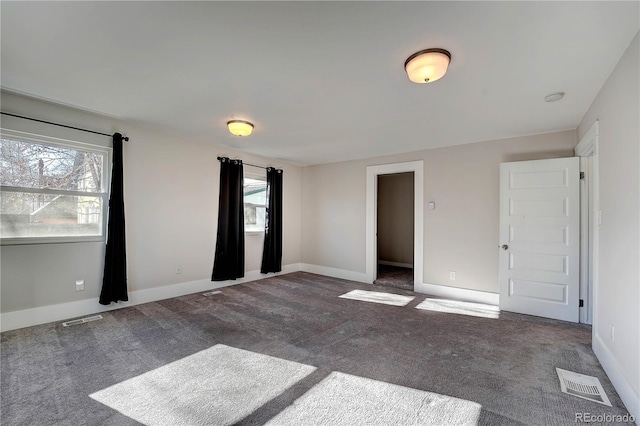 carpeted spare room with a healthy amount of sunlight