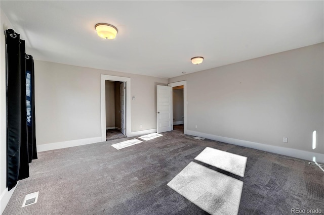 unfurnished bedroom with dark carpet