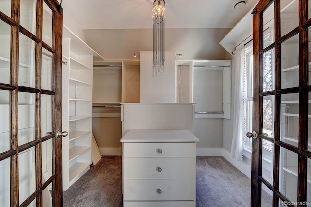 walk in closet featuring dark colored carpet