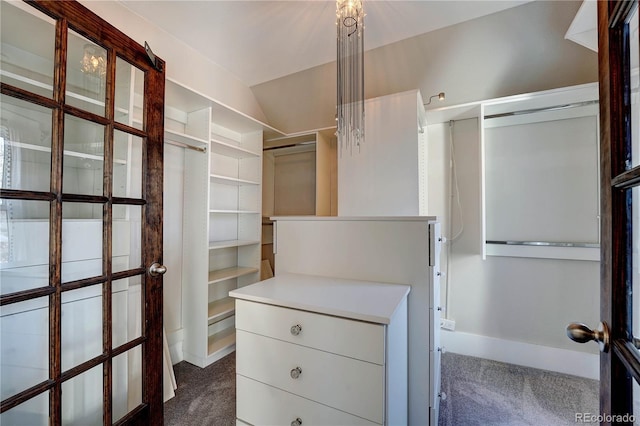 walk in closet featuring dark colored carpet and vaulted ceiling