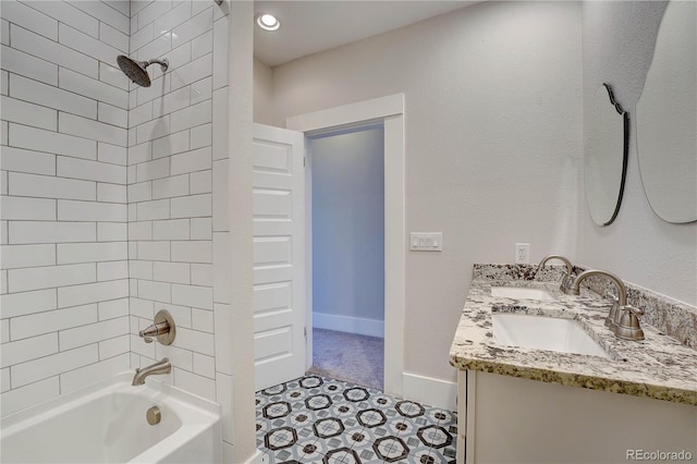 bathroom with vanity and tiled shower / bath