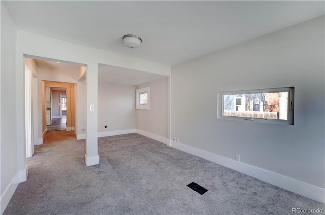 carpeted empty room with a wealth of natural light